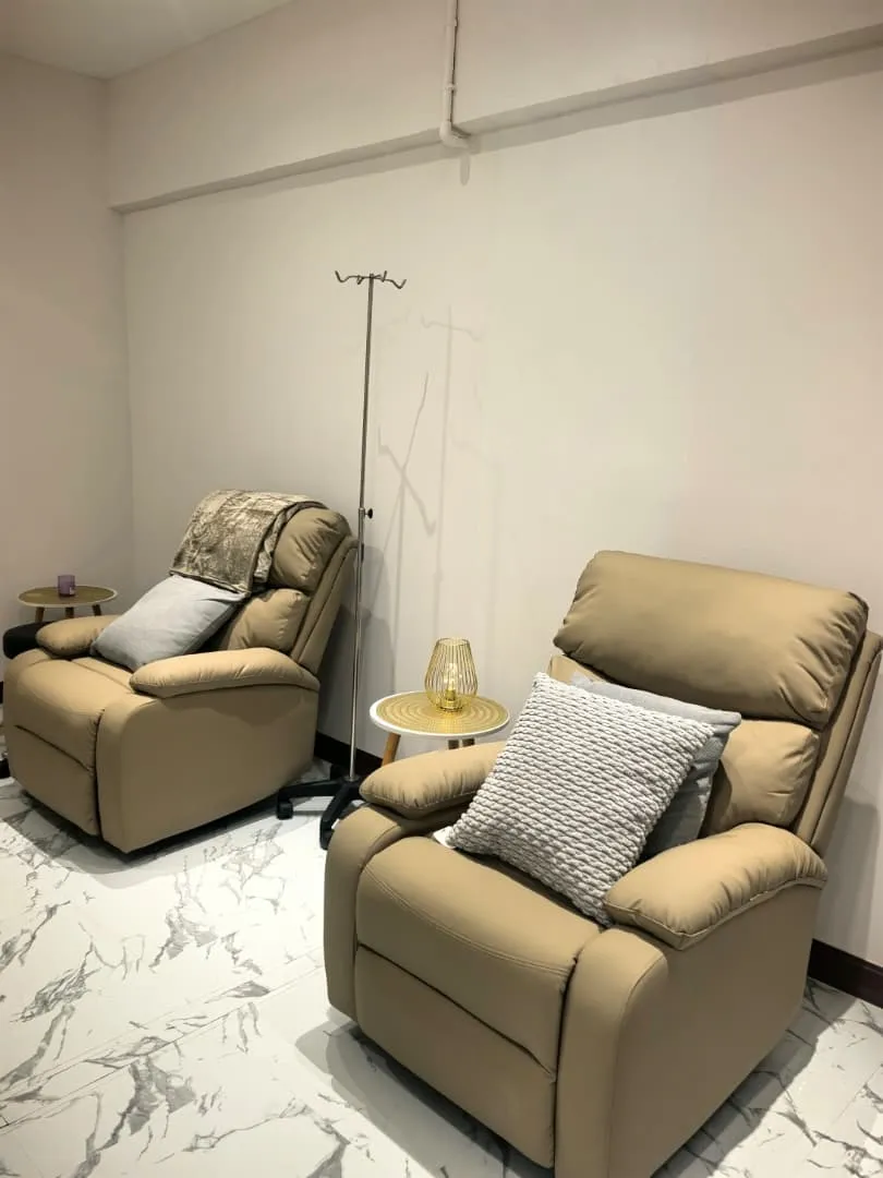 Comfortable recliners in a home treatment room, ready for IV therapy.